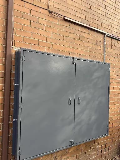 Grey meter box on a brick wall