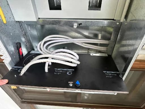 Cables coiled in a metal enclosure